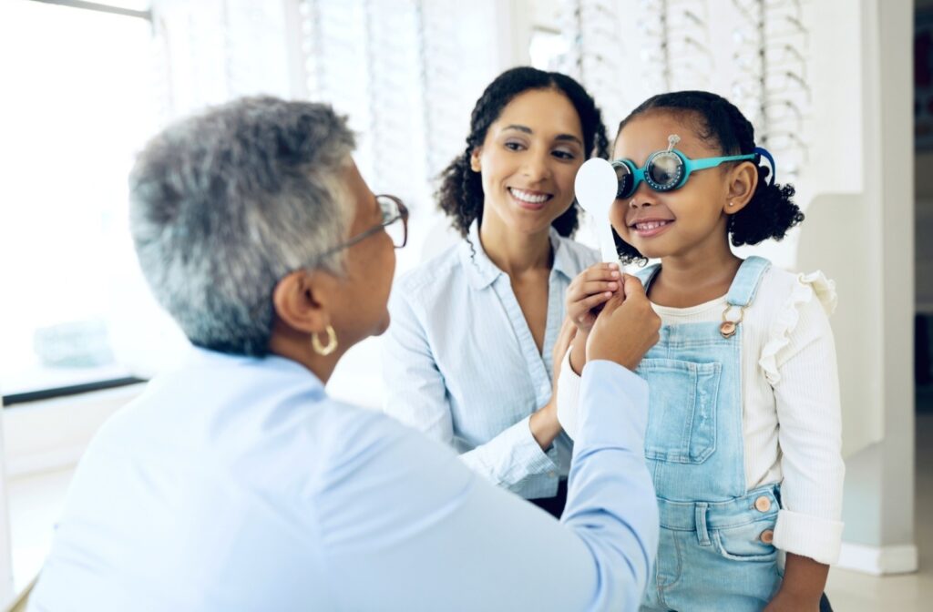 A child getting their eyes checked by an optometrist